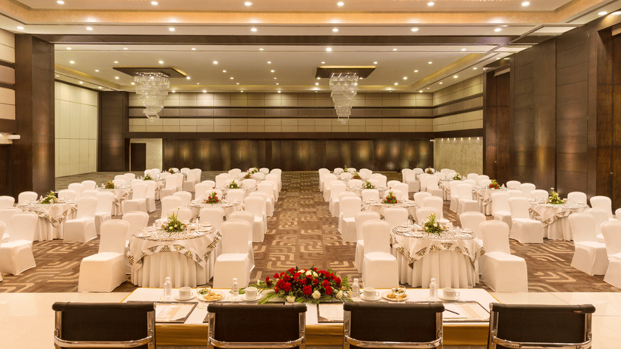 Lavish indoor banquet hall decorated for an event at Narayani Heights Hotel & Resorts, Ahmedabad.