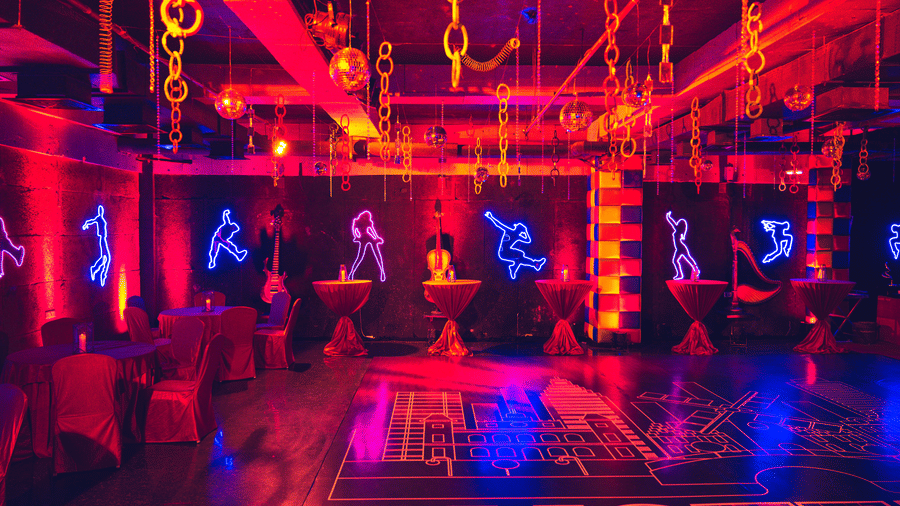 Vibrant dance or fitness studio with neon lights and suspended equipment at Narayani Heights Hotel & Resorts, Ahmedabad.