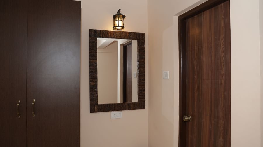 A dressing area at Nazri The Verda Hotel, Arambol, showing a mirror mounted on the wall.