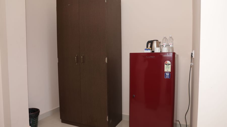 A section of a suite at Nazri The Verda Hotel, Arambol, showing a wardrobe, a red fridge, and an electric kettle on top.