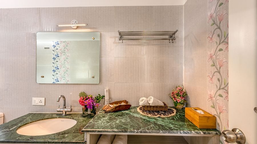an overview of the bathroom with sink area in view inside one of the rooms - neer ganga resorts