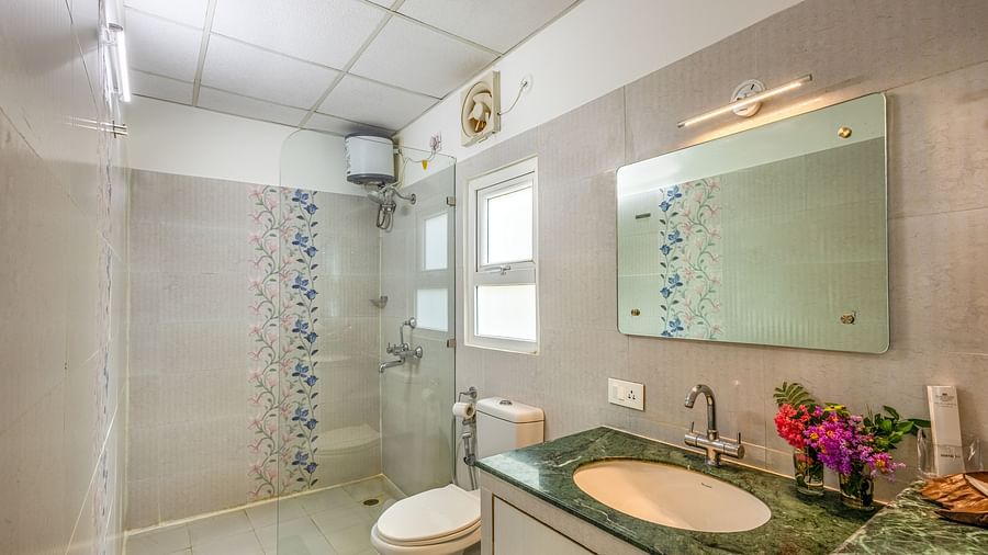 overview of the bathroom with the shower area in view inside one of the rooms - neer ganga resorts