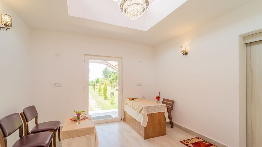 waiting room at the Spa with chairs and tables at Neer Ganga Resorts