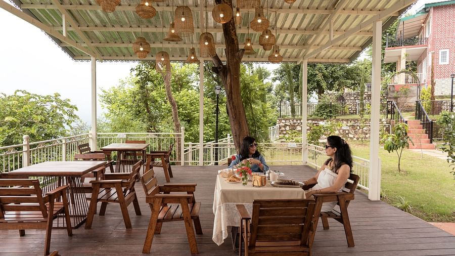 two women sitting on a table having lunch at Neer Ganga Resorts