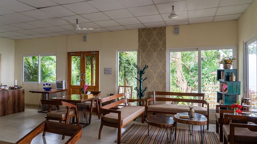 a restuarant with sitting area and modern interiors at Neer Ganga Resorts
