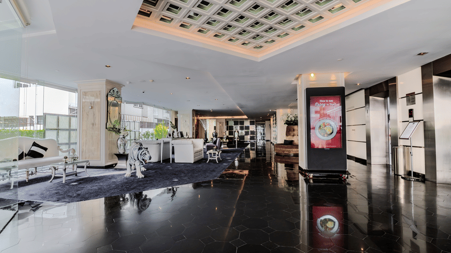 An overview of the lobby area of Night Hotel Bangkok with sofas next to the window.