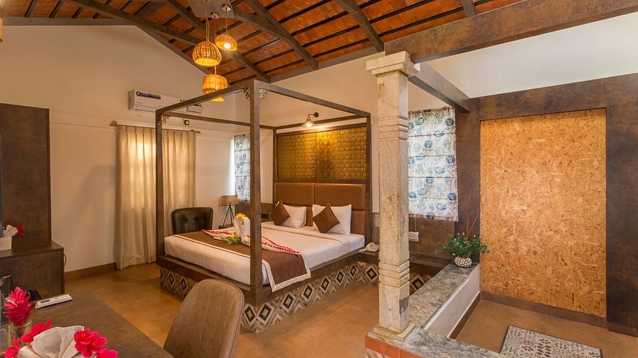 Spacious room with canopy bed and warm lighting at Nirantara Resort & Spa