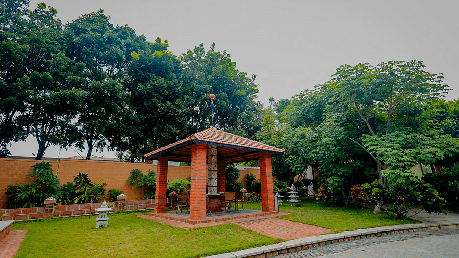 A gazebo or outdoor seating area in a garden at Nirantara Resort & Spa.