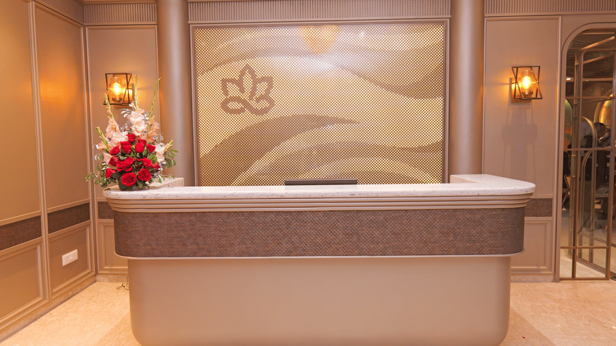 Reception desk with floral decor and warm lighting in the lobby area of Nirvana Gateway.