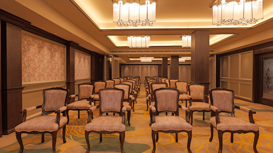 Lotus Banquet at Nirvana Gateway featuring upholstered chairs facing in one direction, and placed over a patterned carpeted floor.