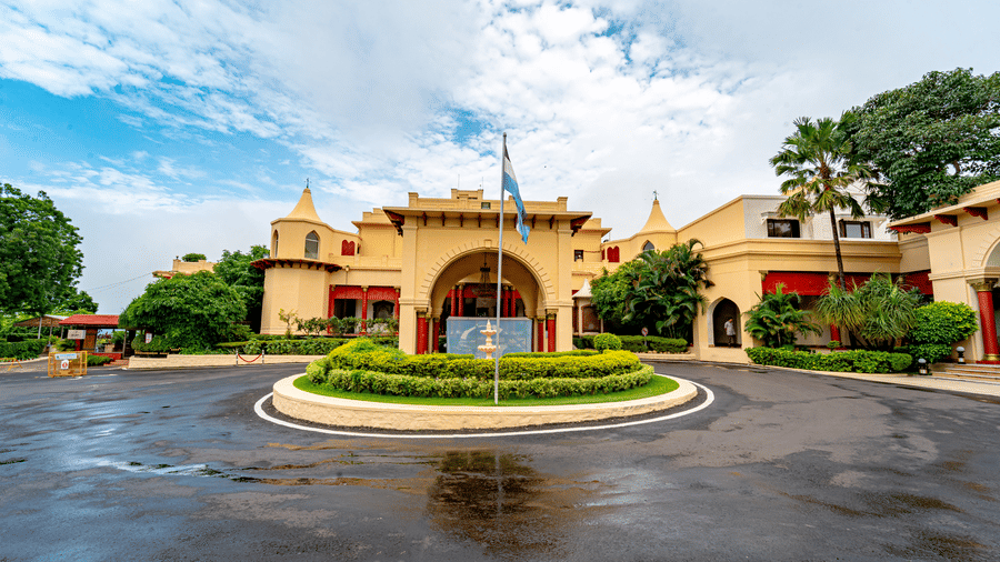 A wide-angle view of the front facade of Noor-Us-Sabah Palace, Bhopal, highlighting the majestic arched entryway and the expansive palace grounds.