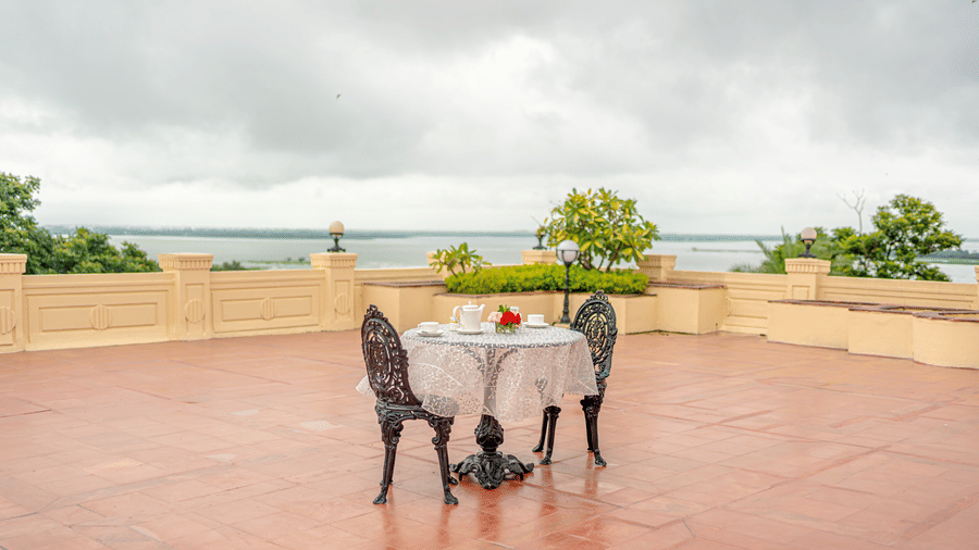 The expansive private terrace of the Presidential Suite at Noor-Us-Sabah Palace, with a tea setting overlooking the scenic Bhopal lake.
