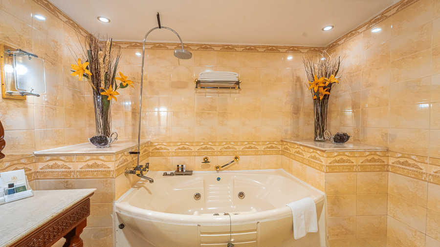Front view of a large Jacuzzi tub in the marble-tiled bathroom of the Presidential Suite at Noor-Us-Sabah Palace.