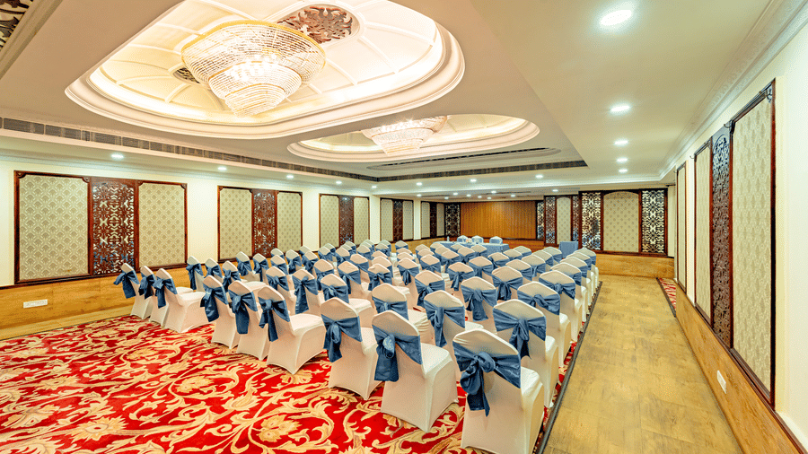 A back shot of the Viceroy banquet hall at Noor-Us-Sabah Palace, Bhopal, featuring neatly arranged chairs in a theatre setting.
