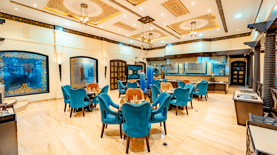 The elegant interior of Za-aiqa, showcasing the spacious seating arrangement, ornate ceiling, and buffet service area.