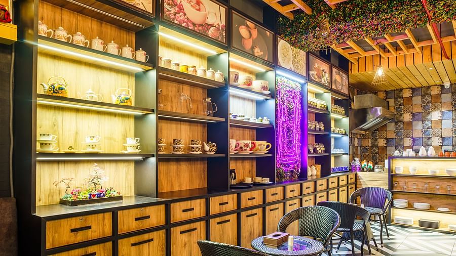 A wide shot of a restaurant at Orsino Spa Resort with walls lined with shelves filled with various items and bottles.