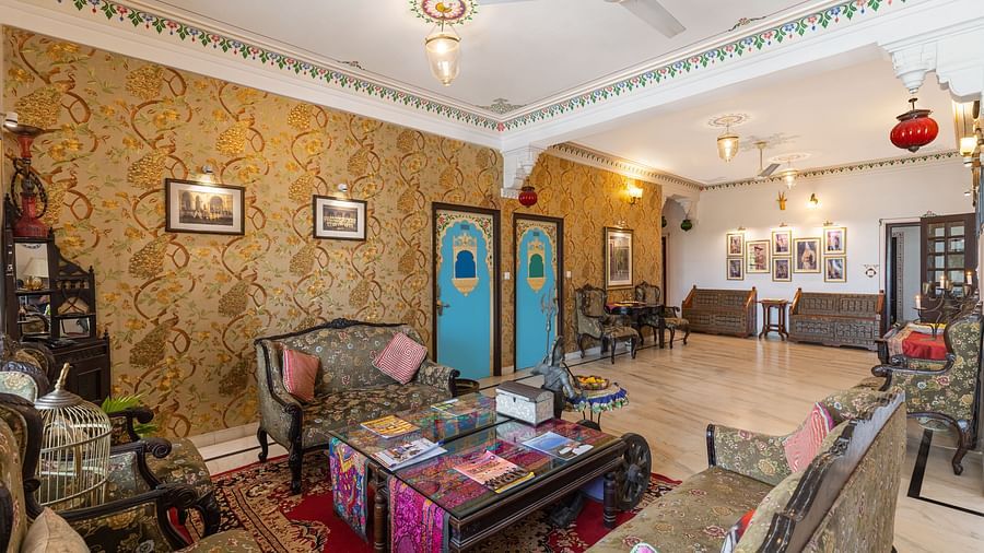 Lobby at Panna Vilas Palace showcases cushioned furniture and a wooden table, enhanced by warm and inviting lighting | Panna Vilas Udaipur