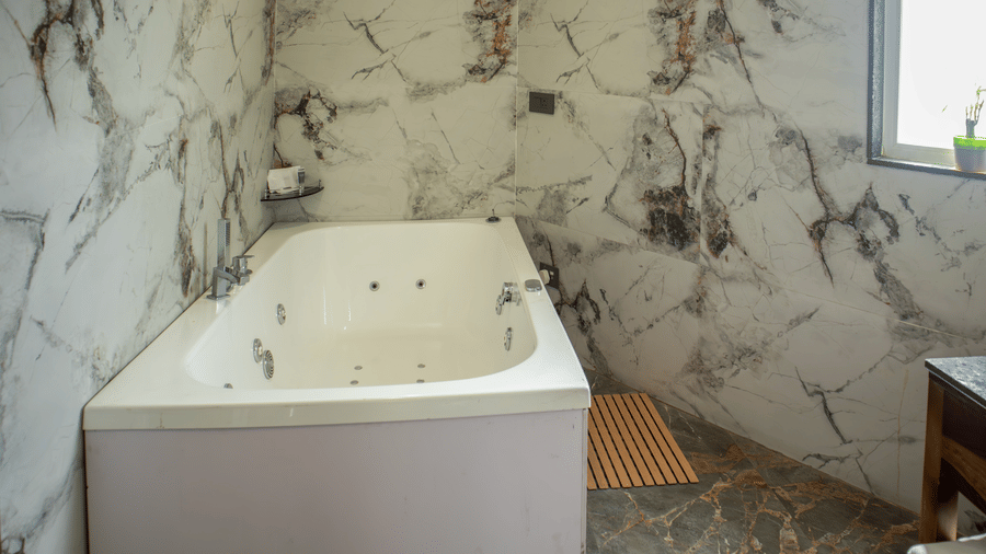 A clean ceramic Jacuzzi with patterned tiles at the Club room of Papaya Tree Hotels.
