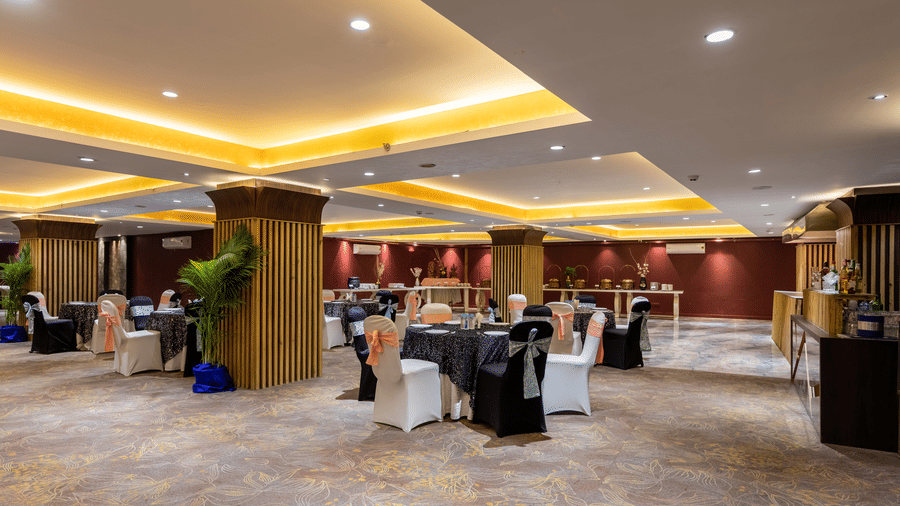 Elegant Galaxy Banquet Hall at Papaya Tree Hotels featuring round dining tables and modern interiors designed for social gatherings.