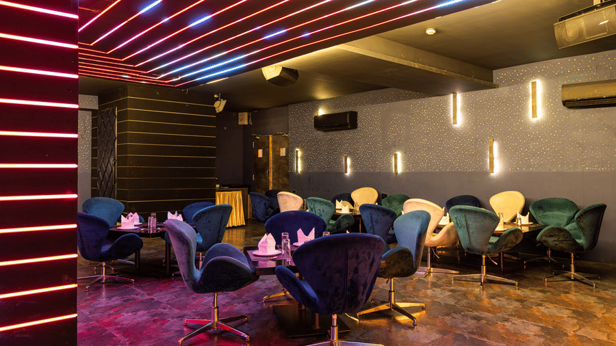 Contemporary indoor dining lounge of Re-Pub-Liq at Papaya Tree Hotels with artistic ceiling lighting and comfortable seating arranged for guests.