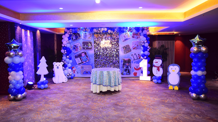 Indoor celebration setup at Galaxy Banquet Hall, Papaya Tree Hotels, featuring a themed stage with balloon decorations and center-piece table for a birthday event.