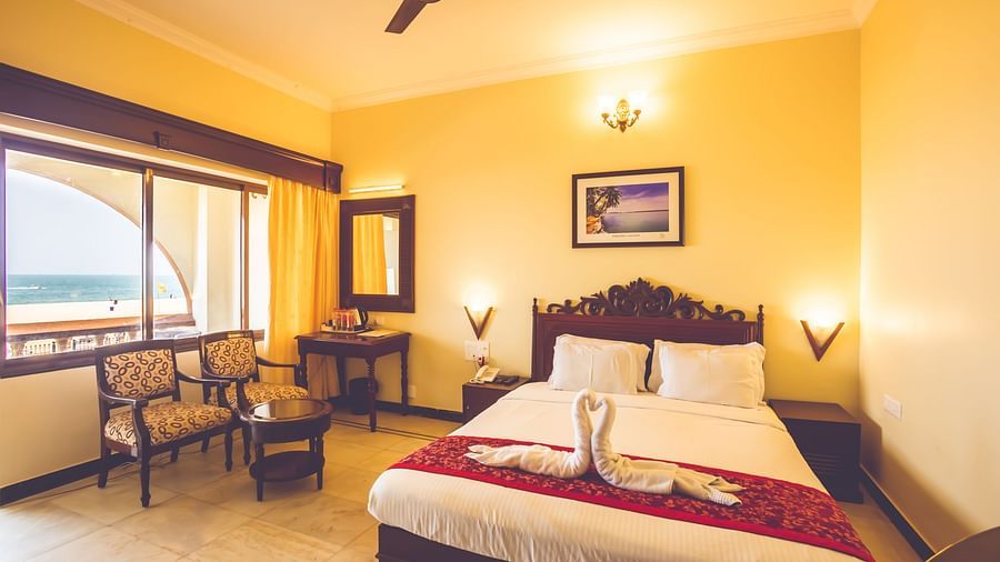 A room at Paradise Isle Beach Resort, Udupi with a double bed and views of the sea from the window