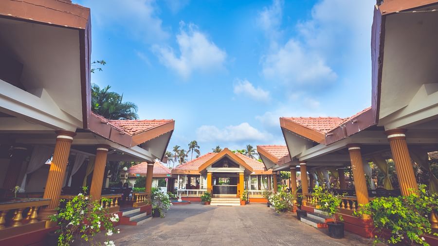 A wide view of the exterior of the cottages at Paradise Isle Beach Resort, Udupi during the day