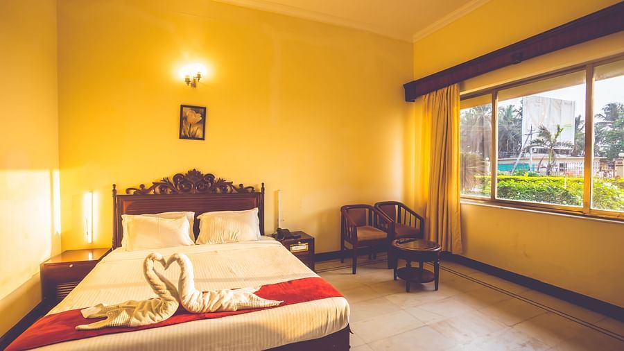 Premium Room at Paradise Isle Beach Resort, Udupi with a double bed and garden views from the window