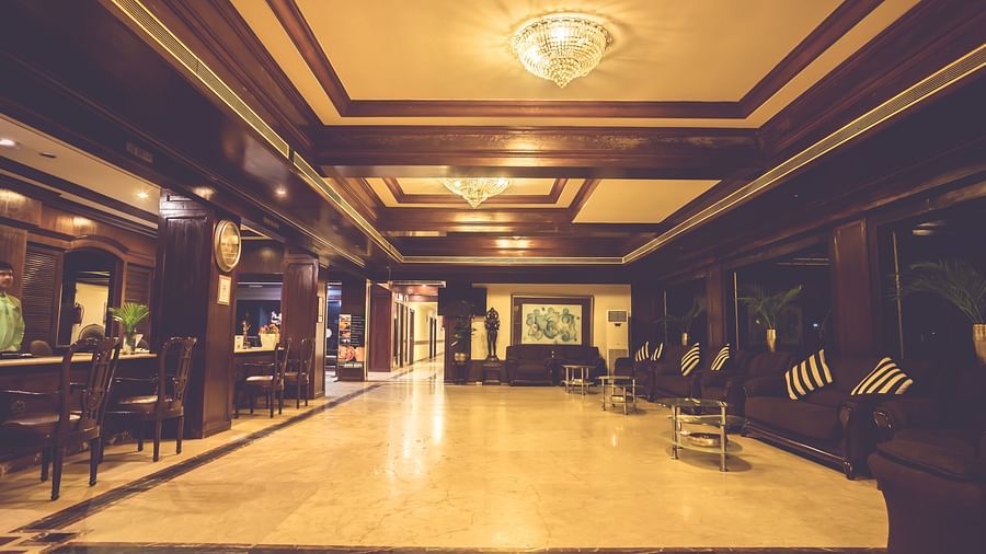 Interiors of the well-lit lobby area of Paradise Isle Beach Resort, Udupi with the reception desk towards the left