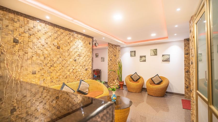 Image of a seating area with ratan furniture at Parampara Residency, Kushalnagar.