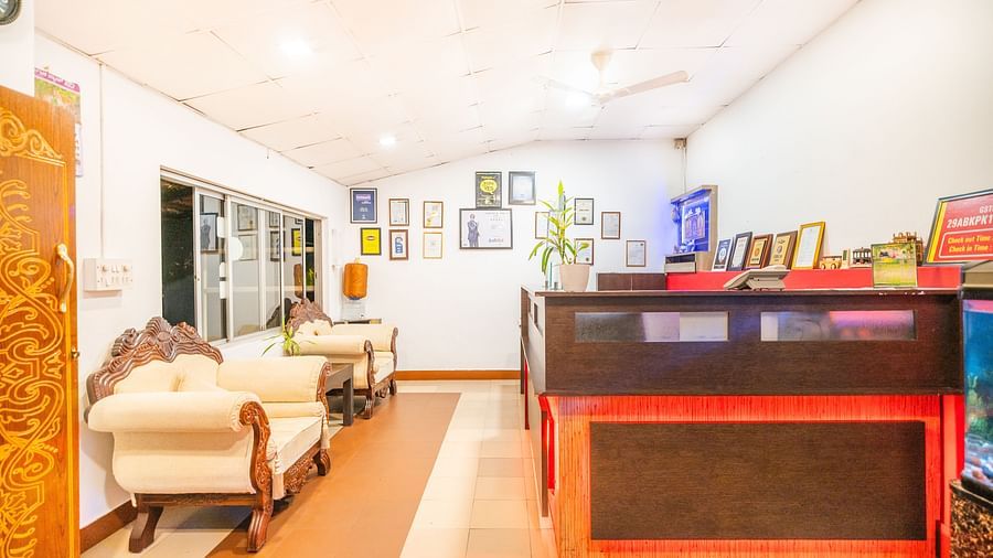 Image of a room with a seating area and a frames on the wall at Parampara Resort & Spa, Kushalnagar.