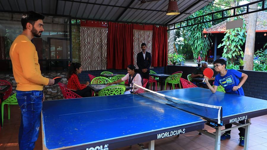 Image of two people playing table tennis at Parampara Resort & Spa, Kushalnagar.