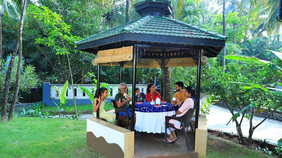 Image of a group of people sitting in a gazebo at Parampara Resort & Spa, Kushalnagar.