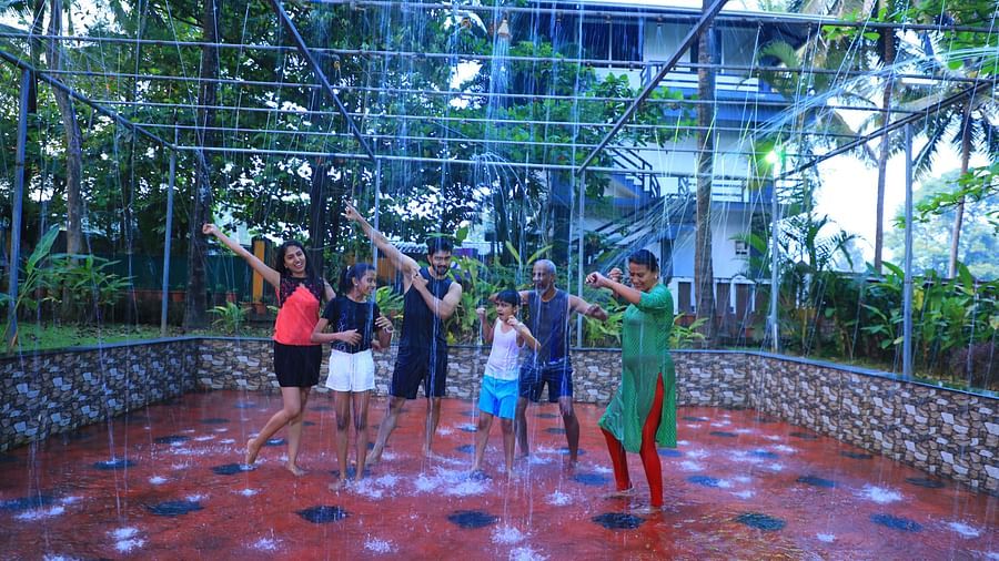 Image of a group of people taking part in a rain dance at Parampara Resort & Spa, Kushalnagar.