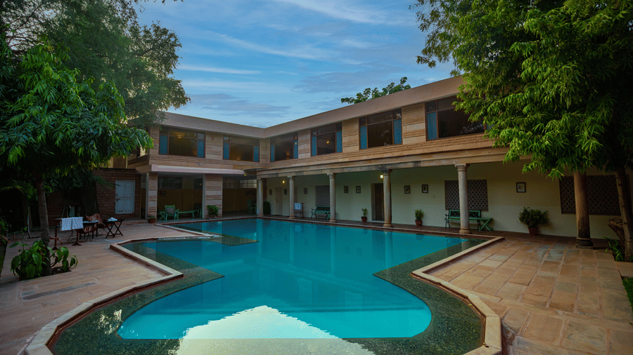 Courtyard swimming pool at Polo Heritage, Managed by Trance, Jodhpur surrounded by heritage-style rooms and shaded seating areas.