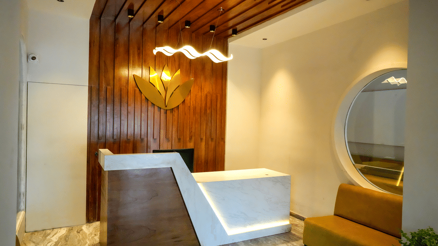 Hotel reception area with counter and seating at Pravasa Hotel, Kolhapur.