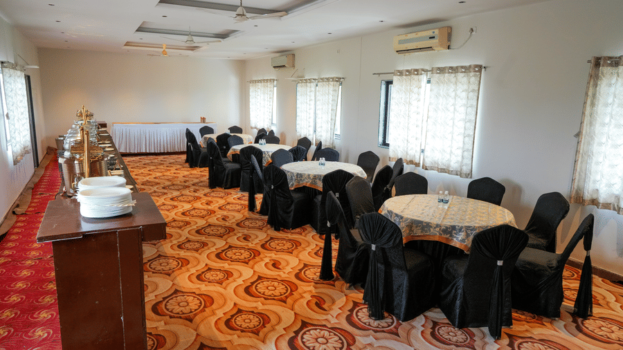 Conference room with chairs and long table setup at Pravasa Hotel, Kolhapur.