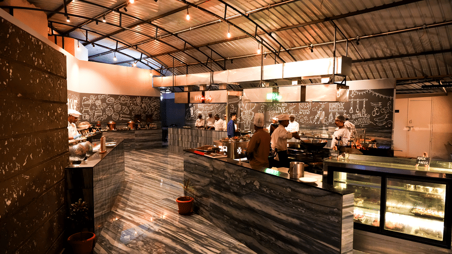 Restaurant buffet counter with “Fire & Smoke” sign at Pravasa Hotel, Kolhapur.