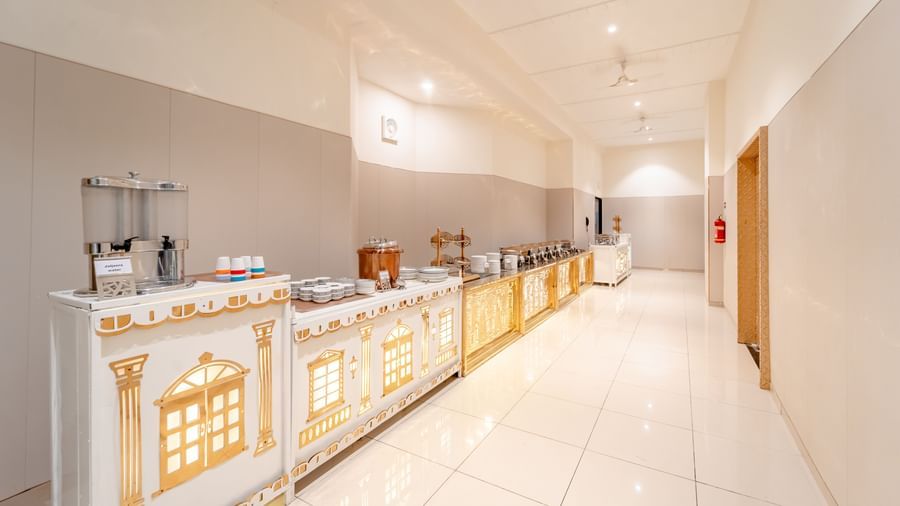 Long buffet counter with various food warmers in a banquet hall | Meetings & Events | Pravasa Hotel, Vijayapura