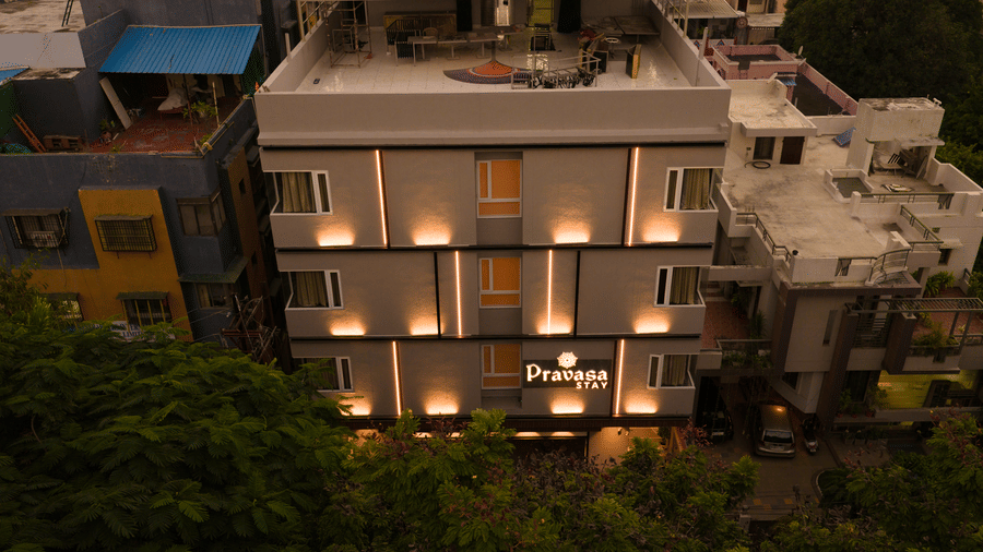 An elevated view of the Pravasa Stay Bapat Square, Indore building, showing the rooftop area.