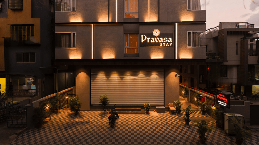 The illuminated parking area and building facade at Pravasa Stay Bapat Square, Indore.