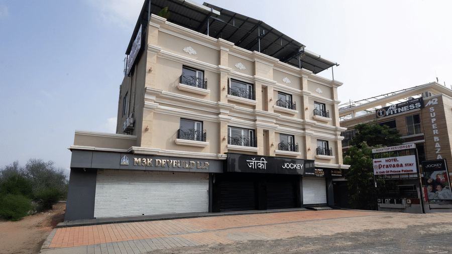 Exterior full view of the three-story building of Pravasa Stay Luv Kush, Indore.