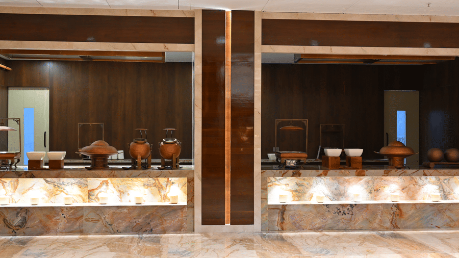 The service counter at Lambic banquet hall in Praveg's Grand Eulogia, Ahmedabad, offering a well-organised setup designed for smooth food service during events.