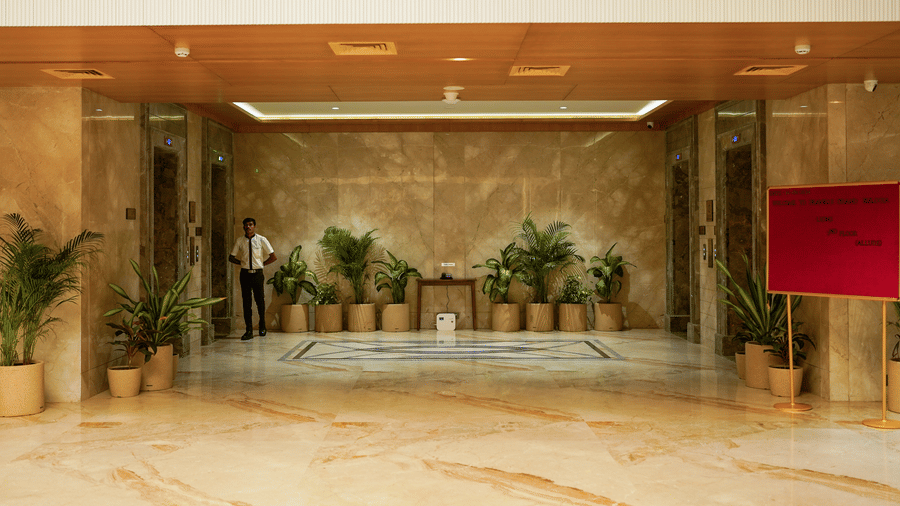 A grand elevator lobby featuring polished marble floors, indoor plants, and clean architectural lines - Praveg's Grand Eulogia, Ahmedabad