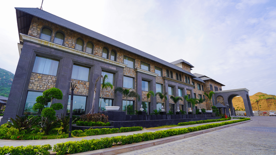 A slightly different perspective of the main resort building, showing the stone and modern glass design.