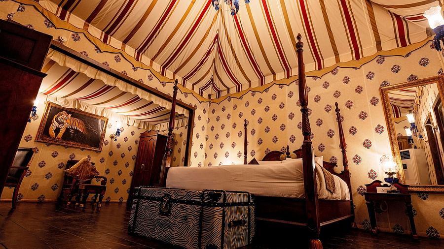 Image of a luxury tent with a bed and a mirror beside the bed Rajasthali Resort & Spa Jaipur.