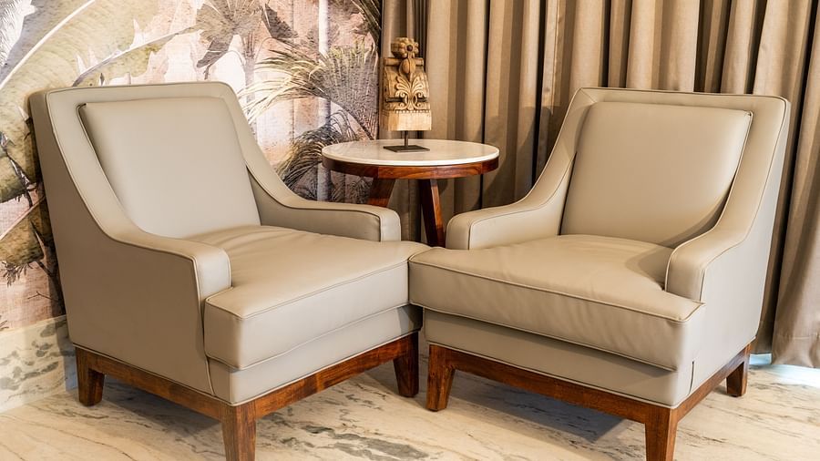 Two cosy cushioned chairs placed adjacent to each other near a round coffee table - Rajbagh Wellness, Udaipur