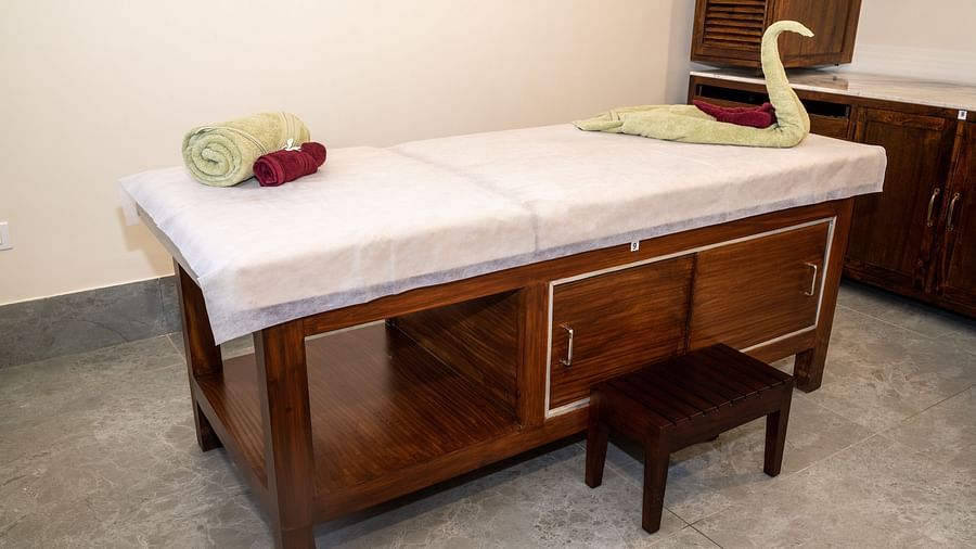 An image of a massage bed where towels are placed - Rajbagh Wellness