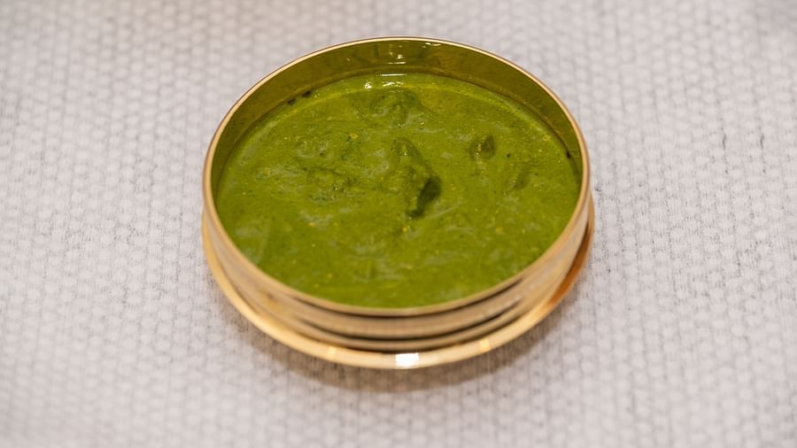 An image of a pot with green paste placed on a table - Rajbagh Wellness