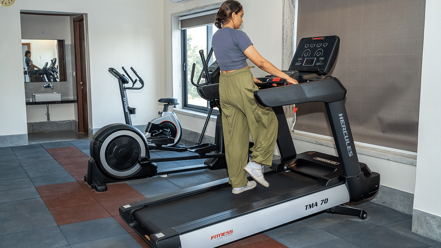 A woman using a treadmill at our gym in Udaipur - Rajbagh Wellness, Udaipur